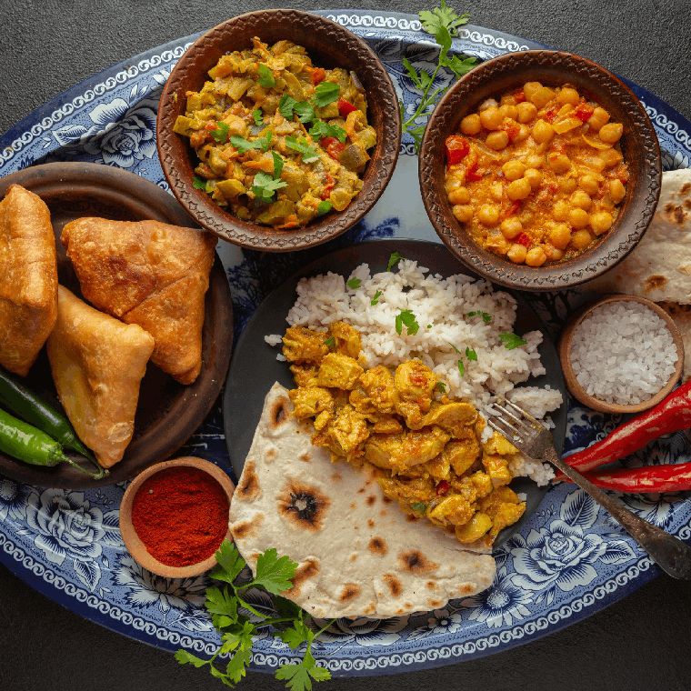 Vegetable Tandoori dish on a plate, garnished with fresh herbs.